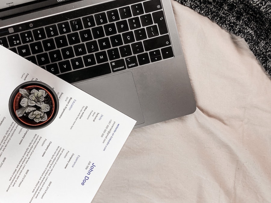 A laptop and a printed CV.